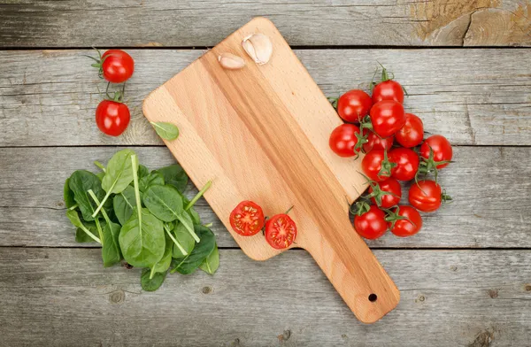 Cherry tomatoes on wooden table — Stock Photo, Image