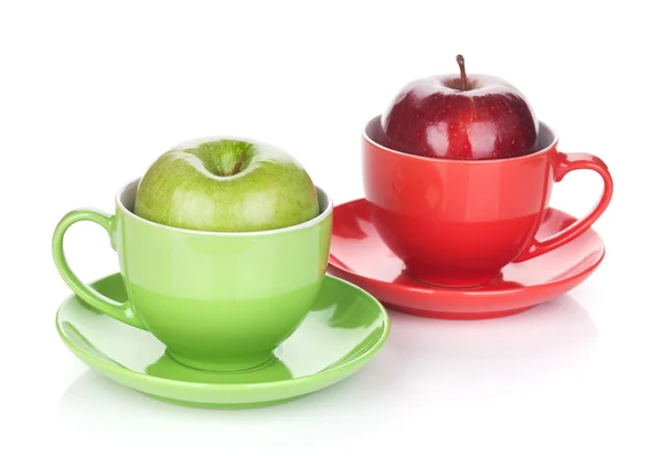 Ripe green and red apple in tea cup — Stock Photo, Image