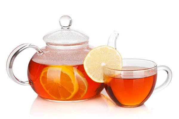 Glass cup and teapot of black tea with lemon — Stock Photo, Image