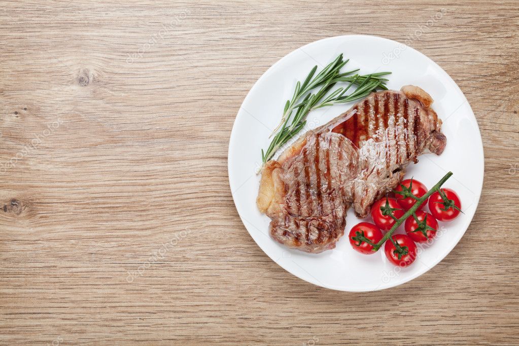 Sirloin steak with rosemary and cherry tomatoes on a plate