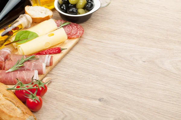 Cheese, prosciutto, bread, vegetables and spices — Stock Photo, Image