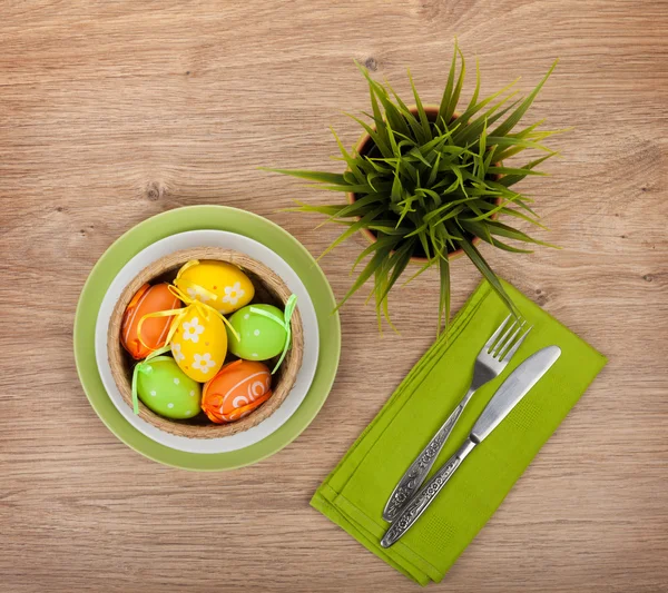 Easter eggs with silverware and potted flower — Stock Photo, Image