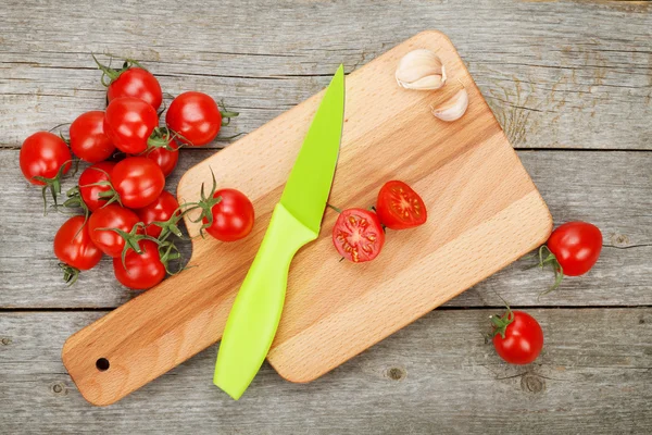 Cherry tomatoes on wooden table — Stock Photo, Image