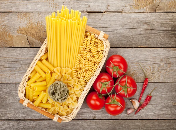 Various pasta, tomatoes and spices — Stock Photo, Image