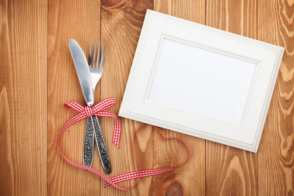 Blank photo frame and silverware — Stock Photo, Image