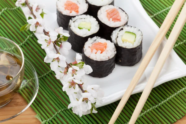 Japanese food and fresh sakura branch — Stock Photo, Image