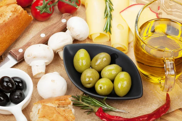 Olives, mushrooms, bread, vegetables and spices — Stock Photo, Image