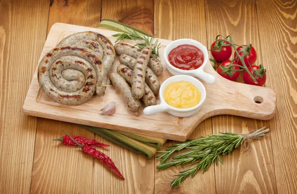 Grilled sausages with ketchup and mustard — Stock Photo, Image