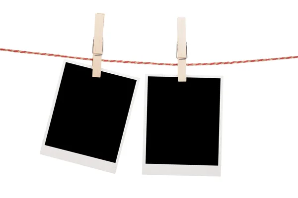 Blank photos hanging on clothesline — Stock Photo, Image