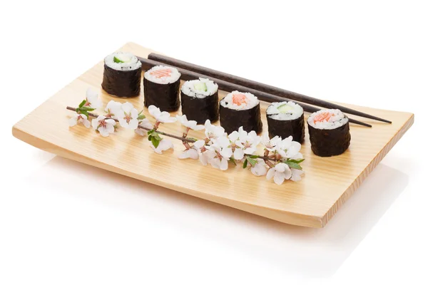 Sushi maki set with salmon and cucumber and sakura branch — Stock Photo, Image