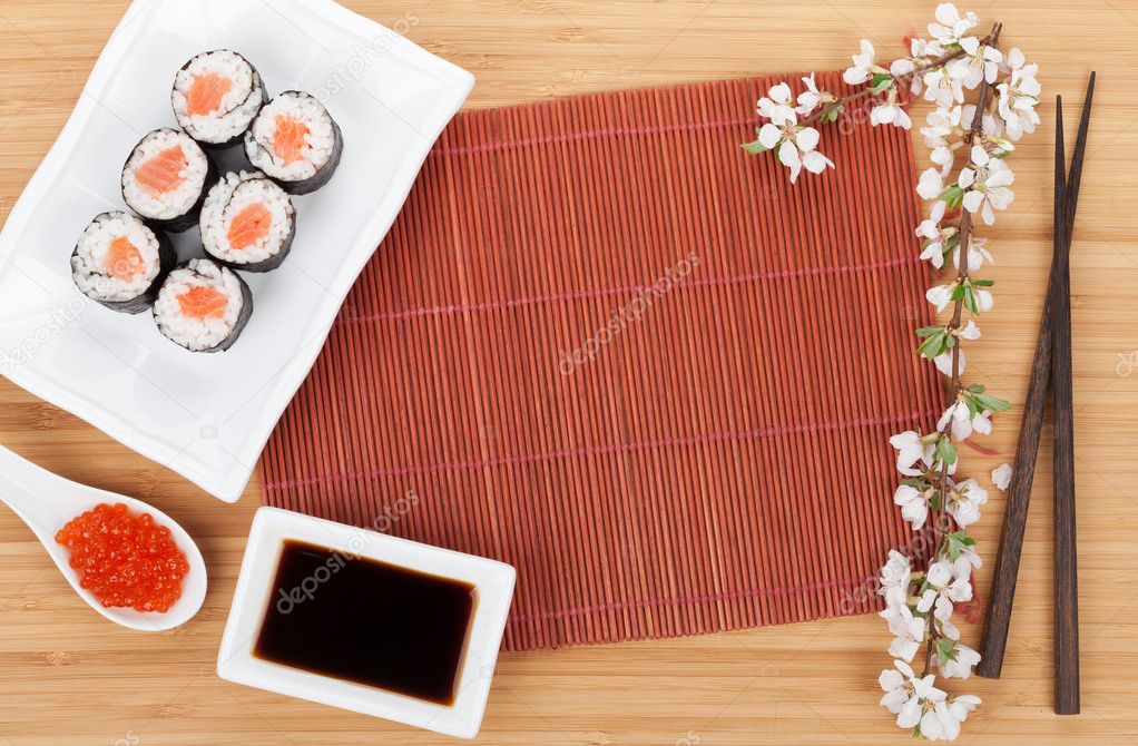 Red caviar, sushi set, sakura branch and chopsticks