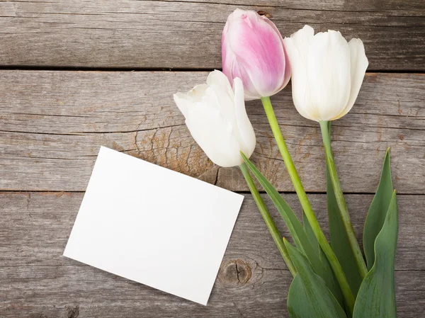 Fresh tulips with greeting card — Stock Photo, Image