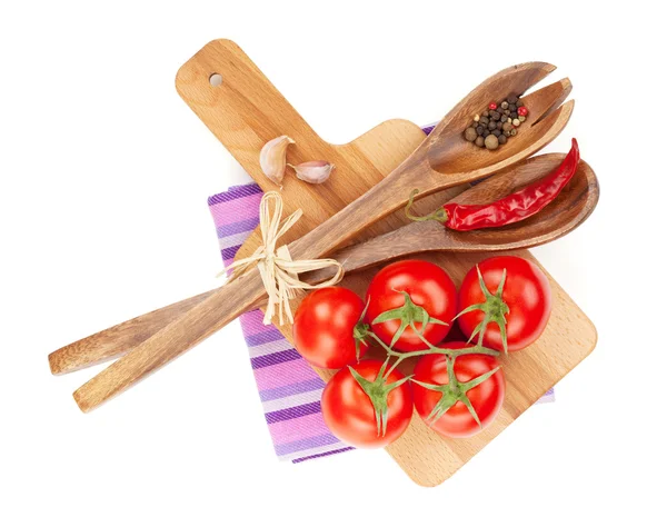 Tomatoes with spices and kitchen utensils — Stock Photo, Image