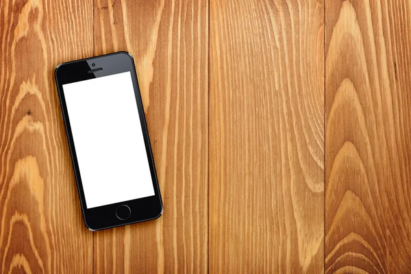 Smart phone on wooden table — Stock Photo, Image