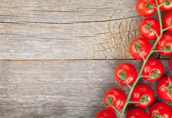 Wood table with cherry tomatoes — Stock Photo, Image