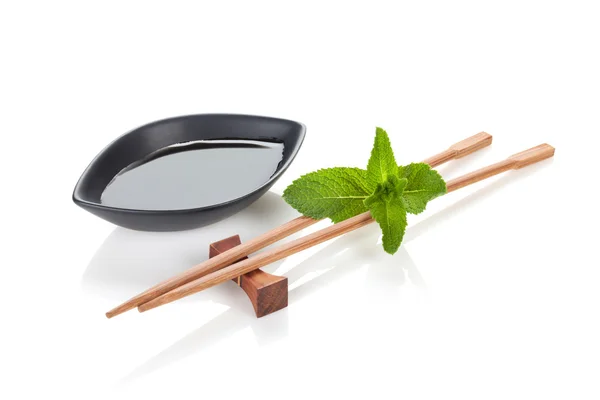 Sushi chopsticks with mint leaves — Stock Photo, Image