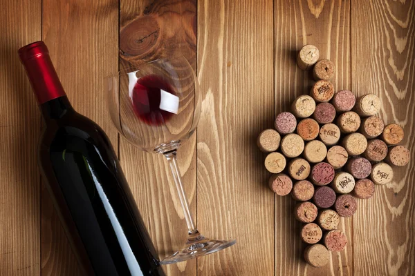 Botella de vino tinto y corchos en forma de uva — Foto de Stock