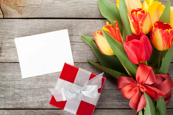 Colorful tulips with gift box and greeting card — Stock Photo, Image