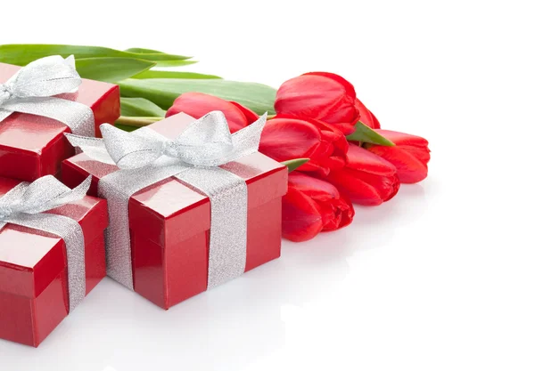 Fresh red tulips with gift boxes — Stock Photo, Image