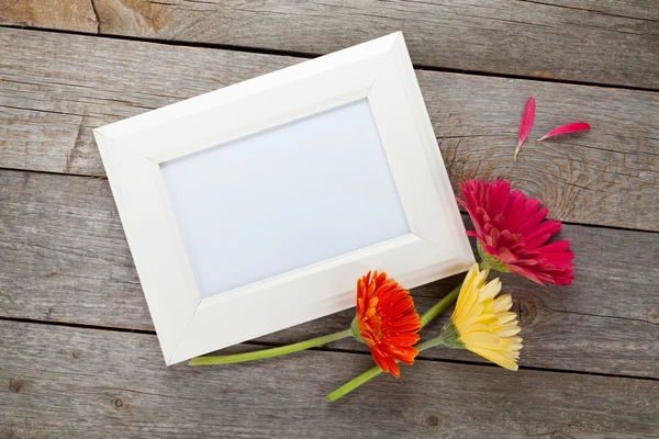Gerbera flowers and photo frame — Stock Photo, Image