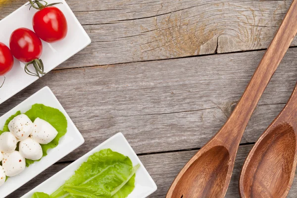 Tomaten, Mozzarella und grüne Salatblätter — Stockfoto