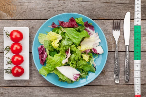 Salad   and kitchen utensils — Stock Photo, Image