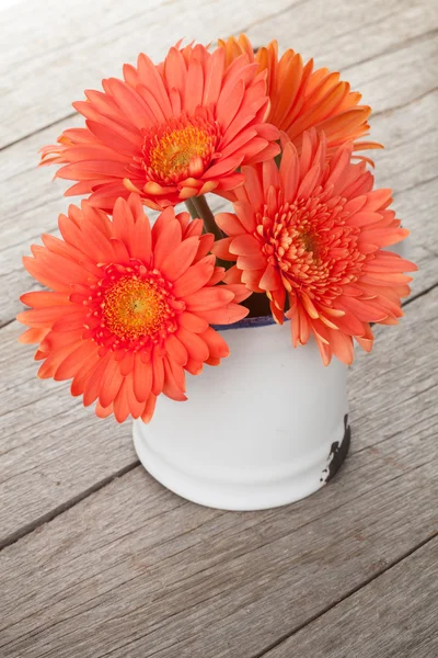 Orange gerbera flowers in pitcher — Stock Photo, Image