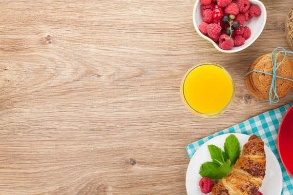 Healty breakfast with muesli, berries, orange juice, coffee and