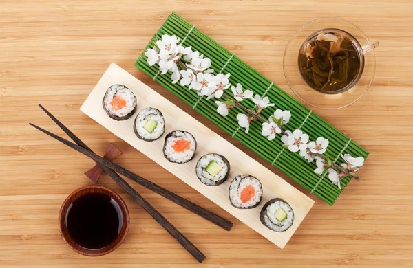 Sushi set with green tea and sakura branch — Stock Photo, Image