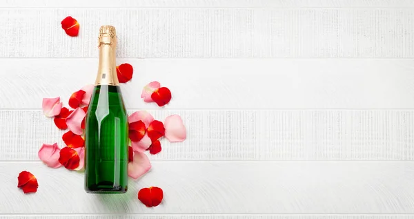 シャンパンボトルとバラの花びら 挨拶のためのスペース付きバレンタインデーグリーティングカード 最上階平面 — ストック写真