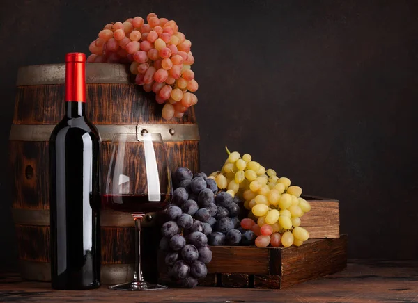 Wine Bottle Grapes Glass Red Wine Old Wooden Barrel Copy Royalty Free Stock Images