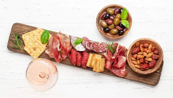 Antipasto Board Prosciutto Salami Crackers Cheese Nuts Olives Rose Wine — Stock Photo, Image