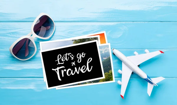 Seyahat ve tatil konsepti. Aksesuarlar ve eşyalar. Güneş gözlükleri, uçak oyuncakları ve seyahat kartları. Üst görünüm düzlüğü