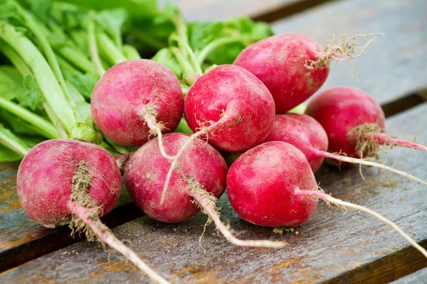Fresh radishes on a wooden board — Stock Photo, Image