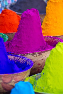 Colorful piles of powdered dyes used for Holi festival in India clipart