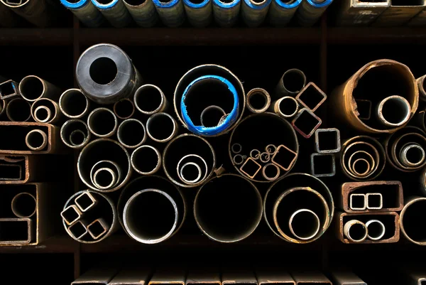 Stacked steel pipes and tubes background — Stock Photo, Image