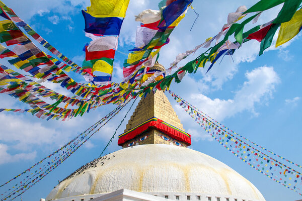 Buddhist shrine Boudhanath Stupa with Buddha wisdom eyes and praying flags in Kathmandu, Nepal