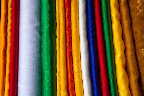 Various of colorful fabrics at a market stall — Stock Photo, Image