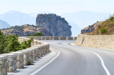 Mountain road curve in Meteora, Greece clipart