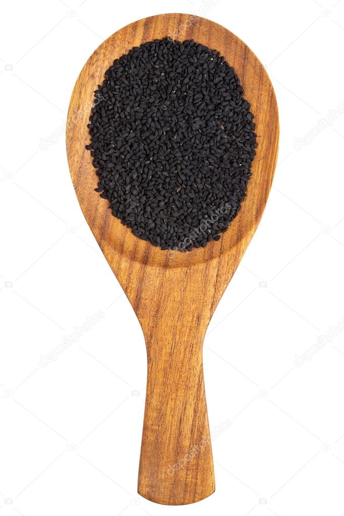 Black cumin or kalonji seeds (Nigella sativa) in the wooden spoon