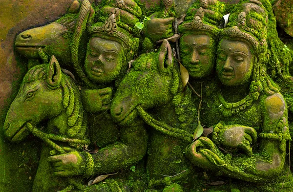 Ancient carvings covered with green moss — Stock Photo, Image