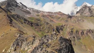 Sırt çantalı bir kadın, Georgia 'daki Kafkasya dağlarında dağ sırtında yürüyüş yapıyor.