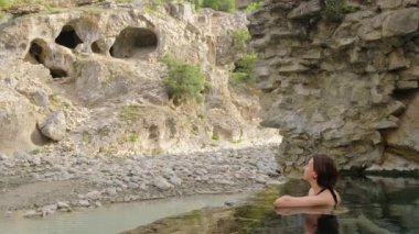 Woman relax in Benja Thermal Baths in Permet, Albania