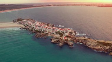 Portekiz 'in batı kıyısındaki Peniche kasabası yakınlarındaki Baleal yarımadasının hava manzarası. Portekiz 'de gün batımında inanılmaz plajları olan Baleal Adası. İnsansız hava aracı görüntüleri. Portekiz seyahat ve sörf merkezi. 