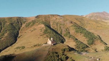 Aerial panorama of Gergeti Trinity Church or Tsminda Sameda in Kazbegi, Georgia. The Church near the village of Gergeti, under Mount Kazbegi in Caucasus mountains, Georgia
