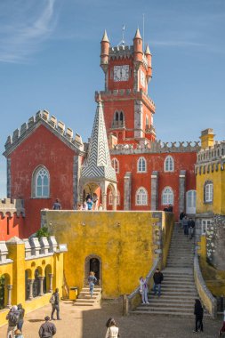 Sintra, Portugal - April 1, 2022: Colorful Pena Palace in Sintra, Portugal. Tourists visiting National Palace of Pena in Sintra region, Lisbon, Portugal