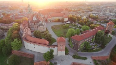 Historic royal Wawel castle in Cracow at sunrise, Poland. Aerial view of the Krakow skyline with Wawel Hill, Cathedral, Royal Wawel Castle, defensive walls. Krakow old town at dawn