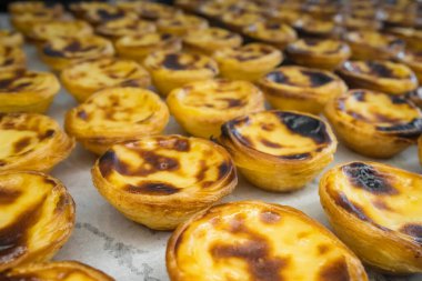 Freshly baked crunchy traditional Portuguese dessert Pastle de Nata with custard on the counter. Portuguese custard tarts Pasteis de nata. Shallow depth of field