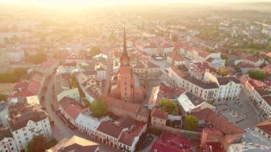 Aerial view of Tarnow old town at sunrise, Poland. Drone footage of the Tarnow cityscape with Cathedral Church of Holy Family, Rynek square with Town Hall and historic buildings at sunny morning. 