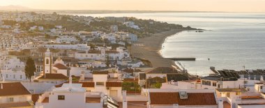 Sunrise panorama of the Albufeira resort town in Algarve province, Southern Portugal. Beautiful morning view of Albufeira cityscape.